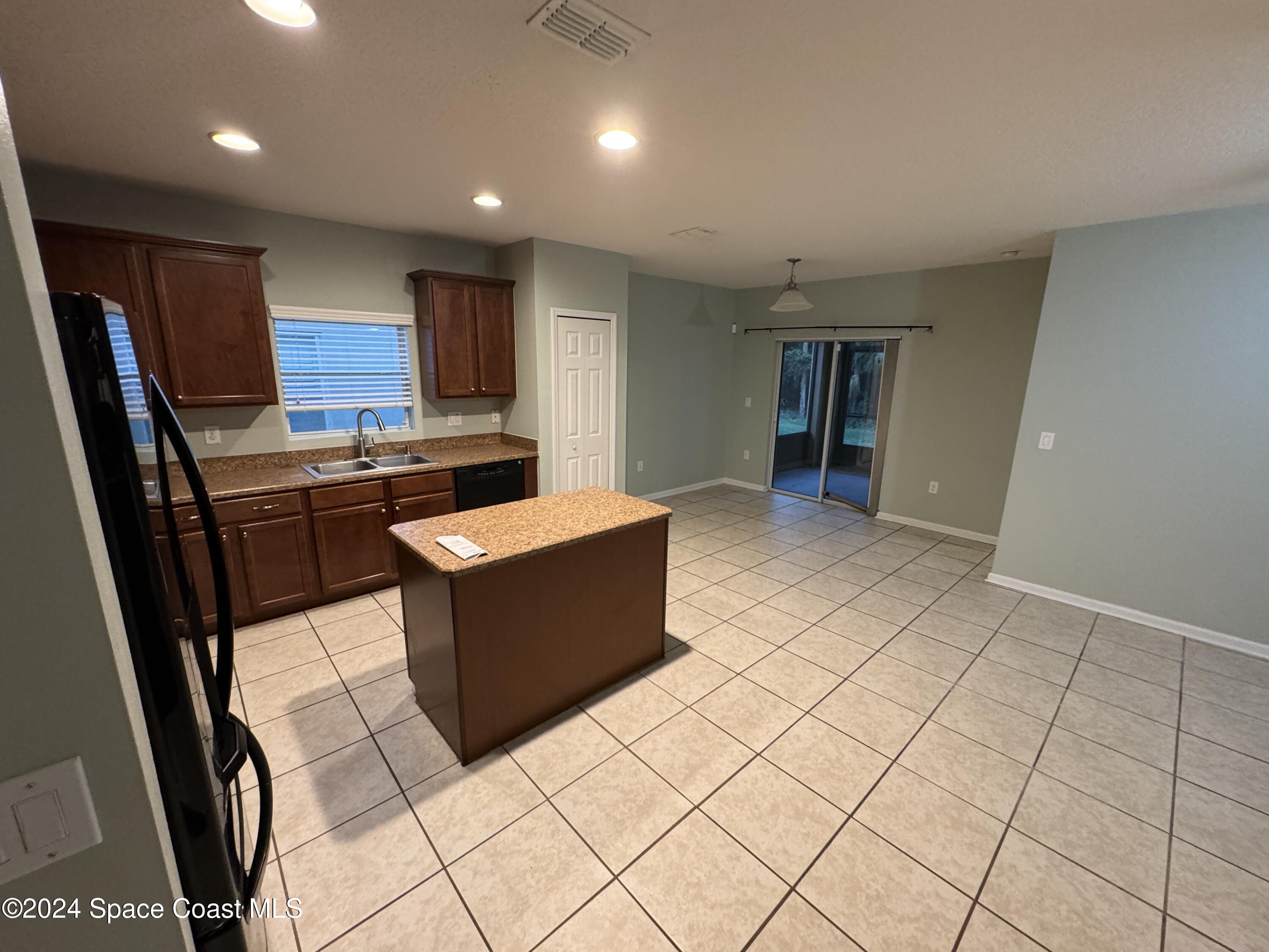 5281 Talbot Boulevard Cocoa, FL 32926 - Photo 9 of 31 a kitchen with stainless steel appliances kitchen island granite countertop a sink and cabinets