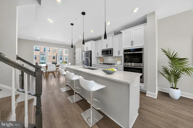 a kitchen with white cabinets and counter space