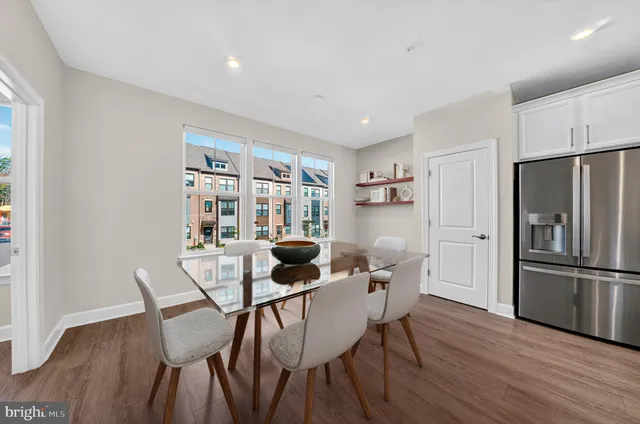 a dining room with furniture and wooden floor