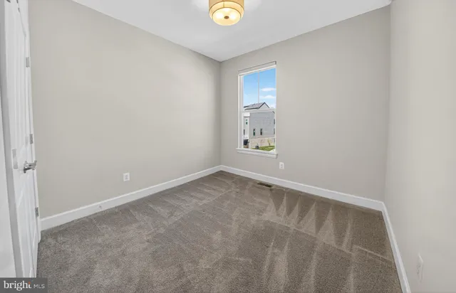 a bedroom with a bed and a potted plant