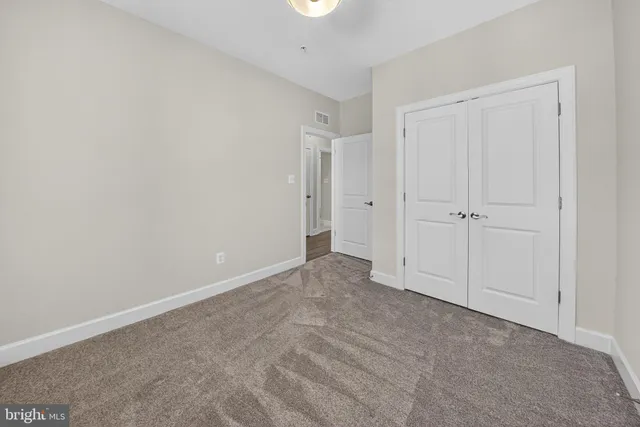 a living room with furniture potted plant and a wooden floor