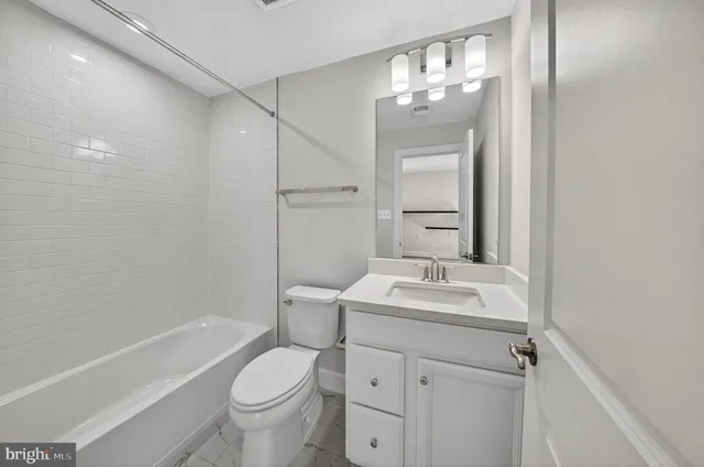 a bathroom with a sink toilet tub and shower