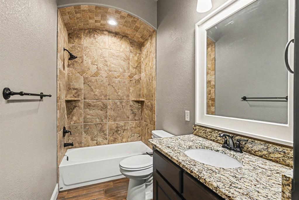 104 Stanford Lane Springtown, TX 76082 - Photo 21 of 28 a bathroom with a granite countertop sink toilet and shower