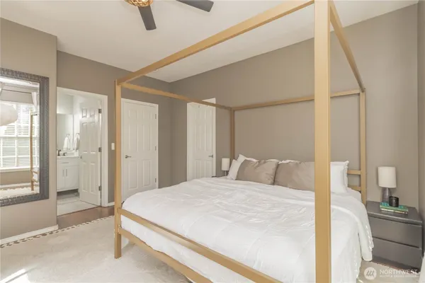 a bedroom with a large bed and a chandelier