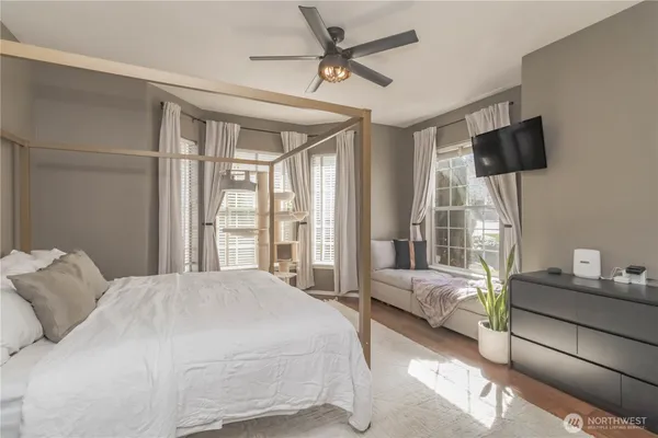 a bedroom with a bed window and couch