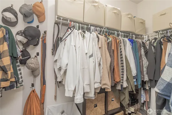 a view of walk in closet with clothes and shoes