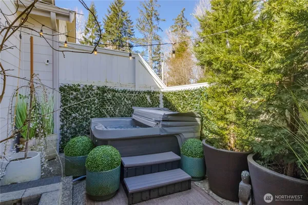 a view of a backyard with plants and outdoor seating