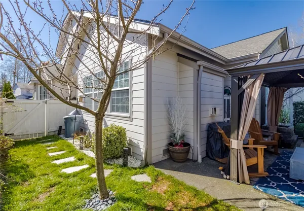 a view of a backyard with plants and a patio