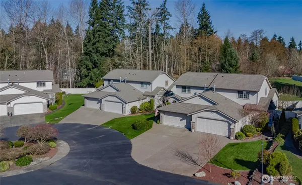 an aerial view of a house with garden space and street view
