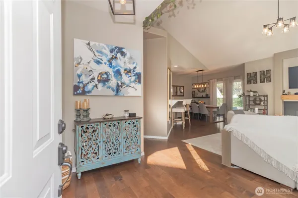 a living room with furniture a table and kitchen view