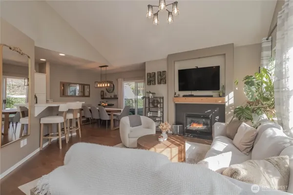 a living room with furniture a fireplace and a flat screen tv