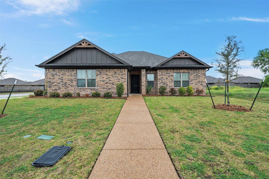 View of front of home featuring board and batten siding and brick siding