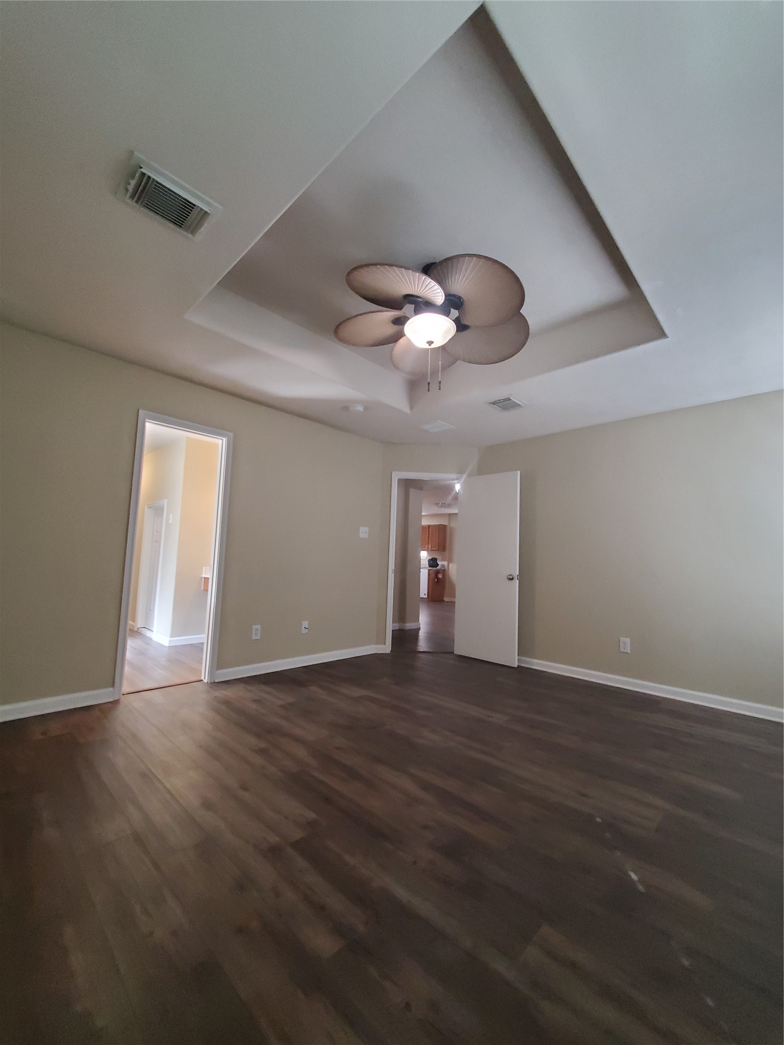9342 Canady Park Lane Houston, TX 77075 - Photo 12 of 25 a view of an empty room with wooden floor and a ceiling fan
