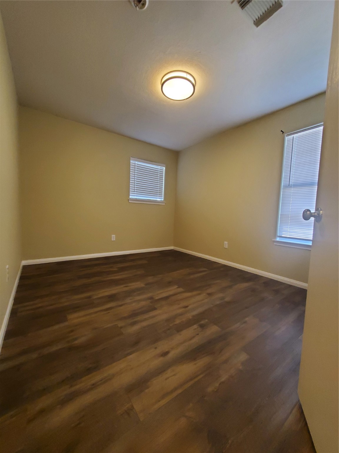 9342 Canady Park Lane Houston, TX 77075 - Photo 18 of 25 an empty room with wooden floor and windows