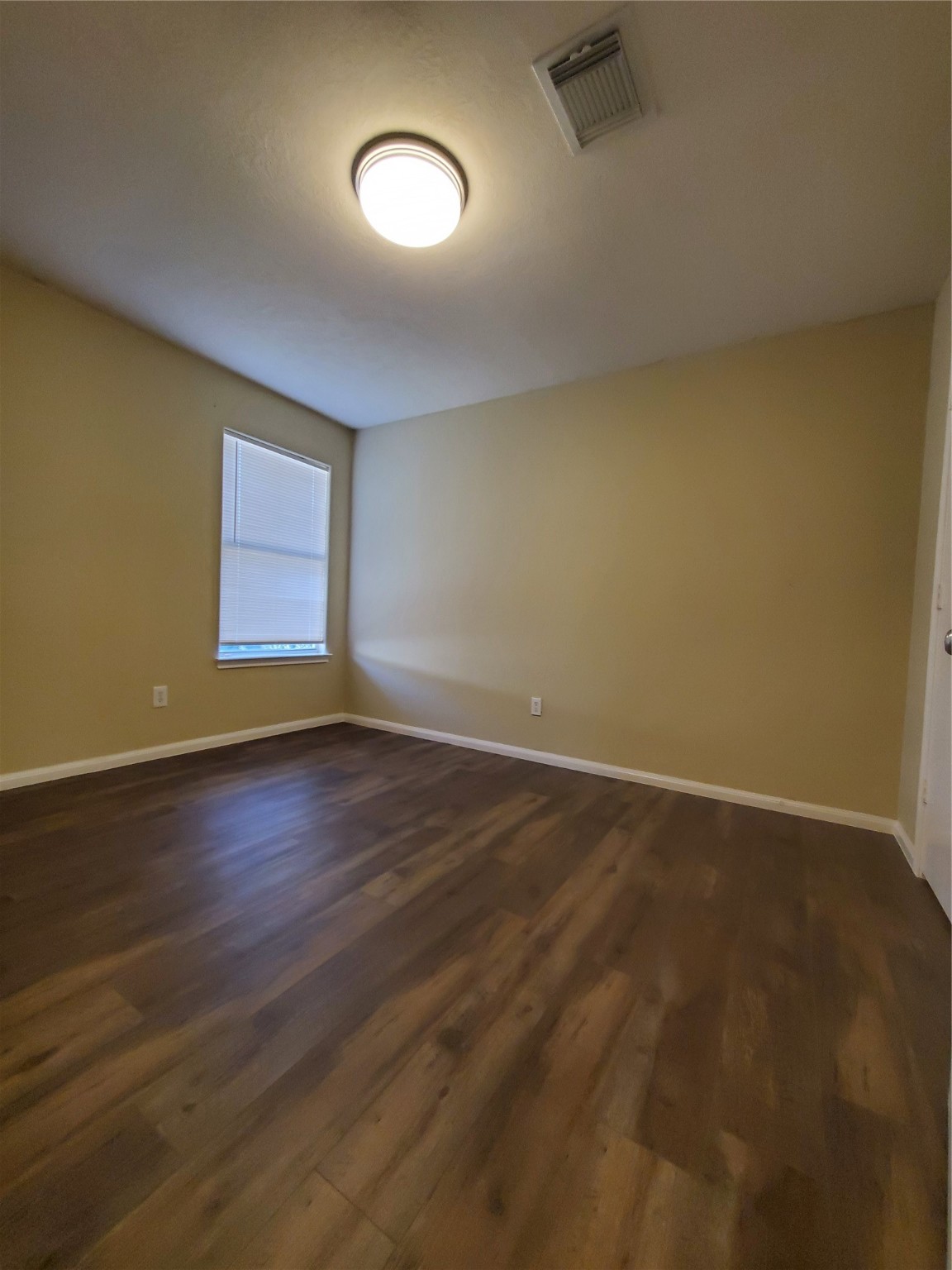 9342 Canady Park Lane Houston, TX 77075 - Photo 20 of 25 an empty room with wooden floor and windows