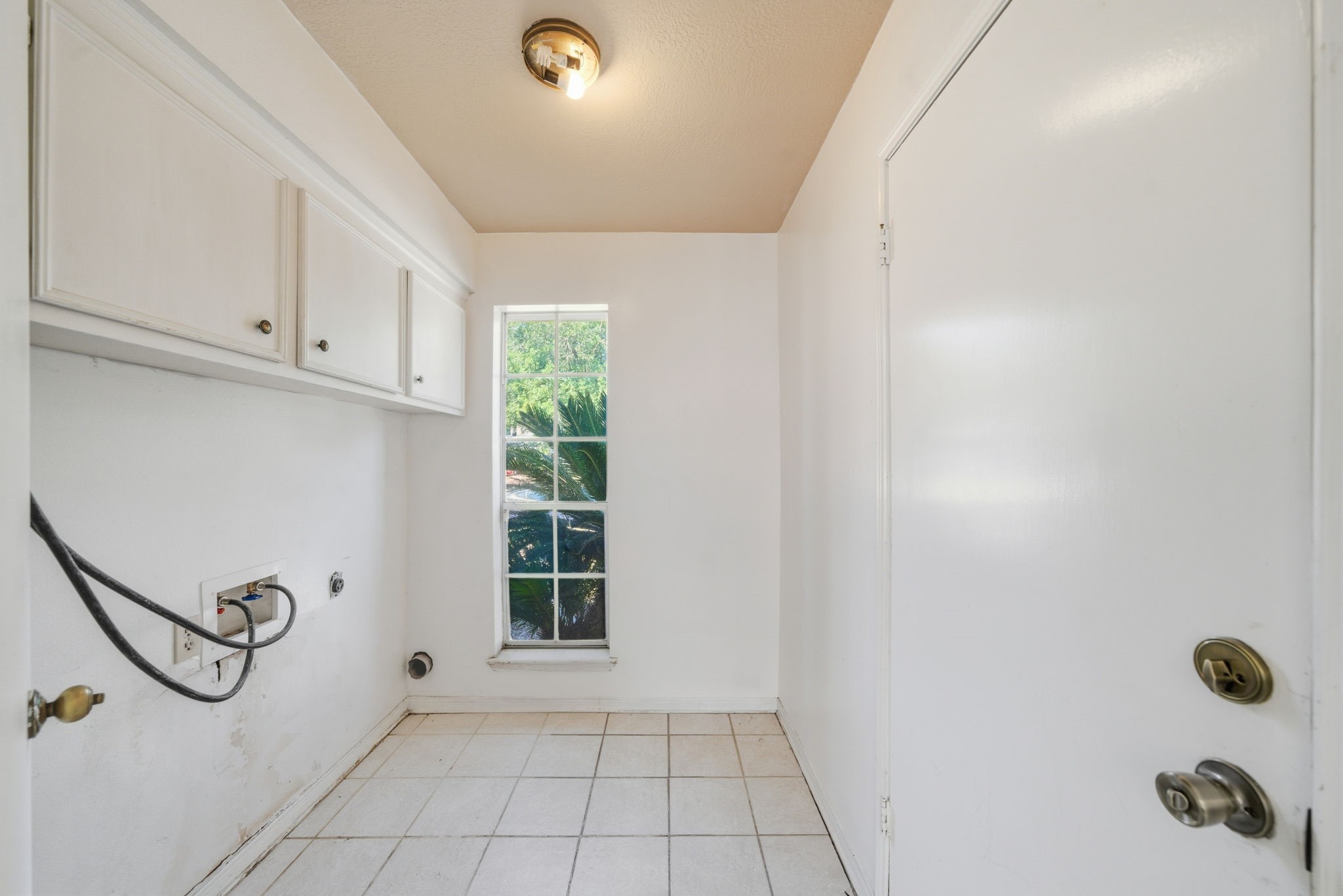 6919 River Mill Drive Spring, TX 77379 - Photo 16 of 20 a bathroom with white cabinets washer and dryer