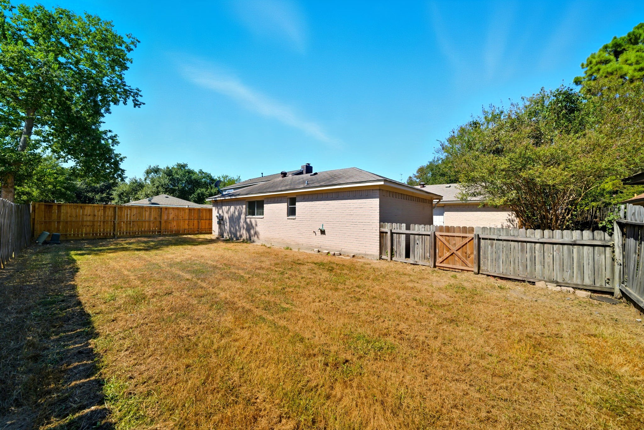 6919 River Mill Drive Spring, TX 77379 - Photo 20 of 20 a view of a white house in the back yard