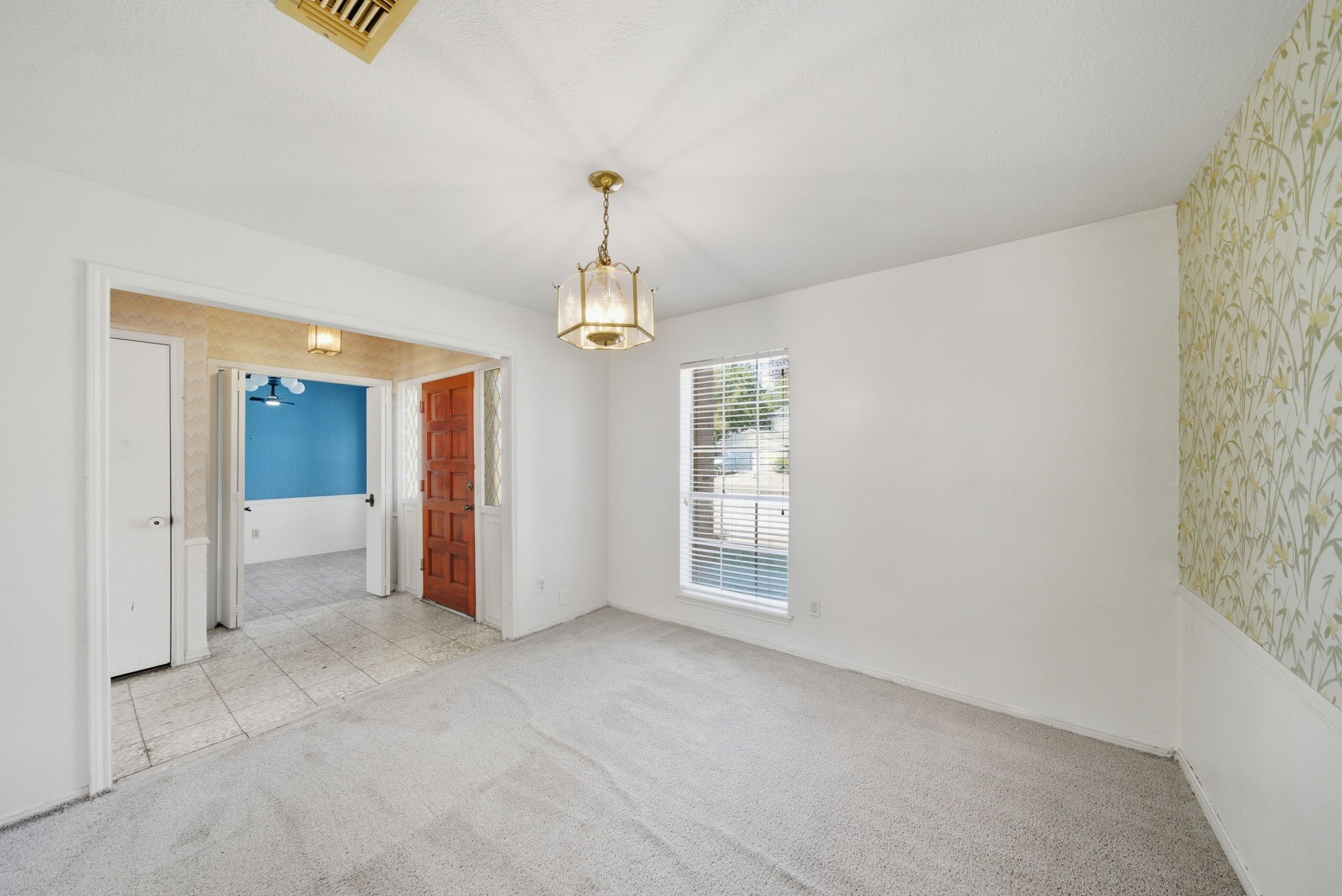 6919 River Mill Drive Spring, TX 77379 - Photo 5 of 20 a view of an empty room with chandelier and window