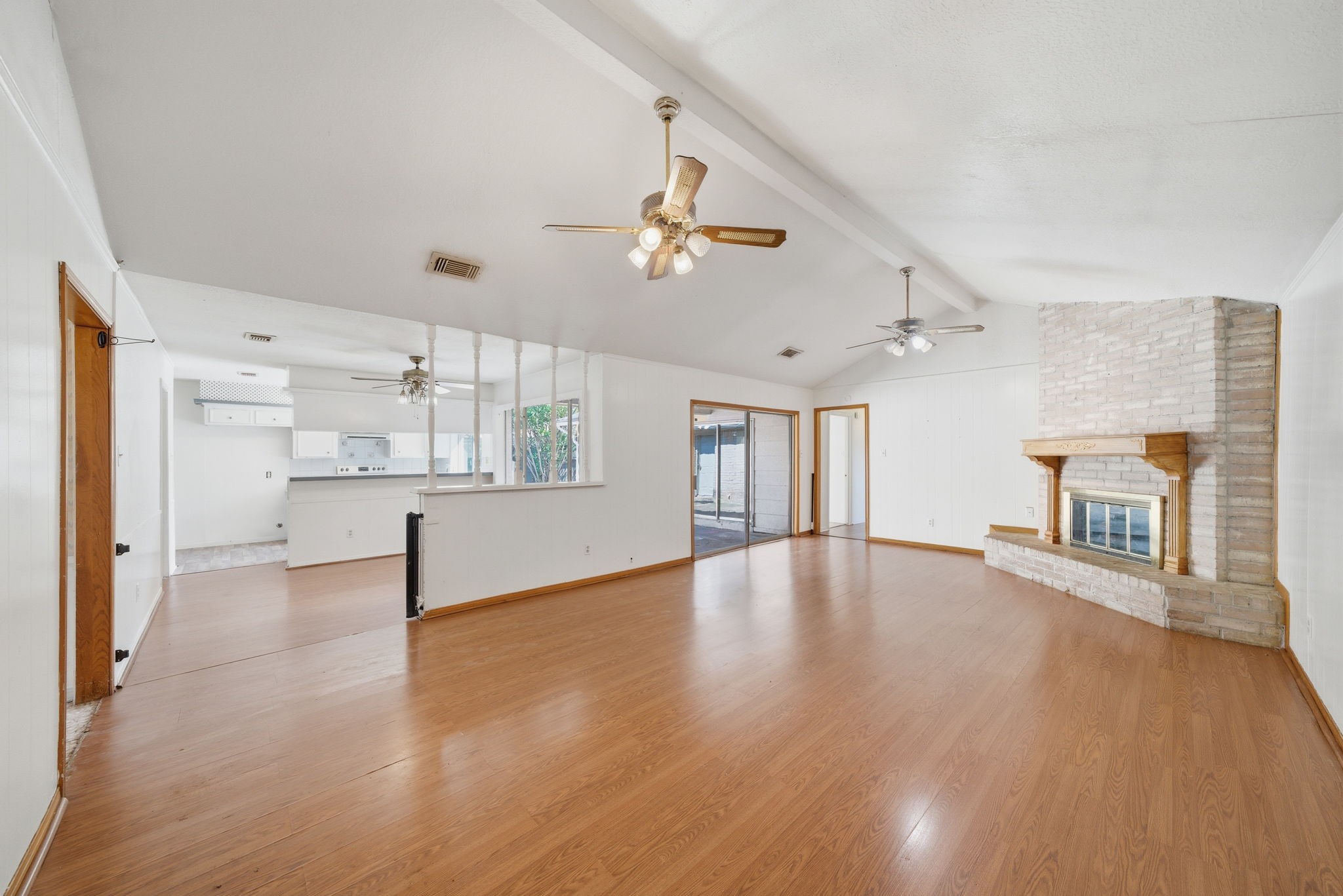 6919 River Mill Drive Spring, TX 77379 - Photo 7 of 20 an empty room with wooden floor fireplace and windows