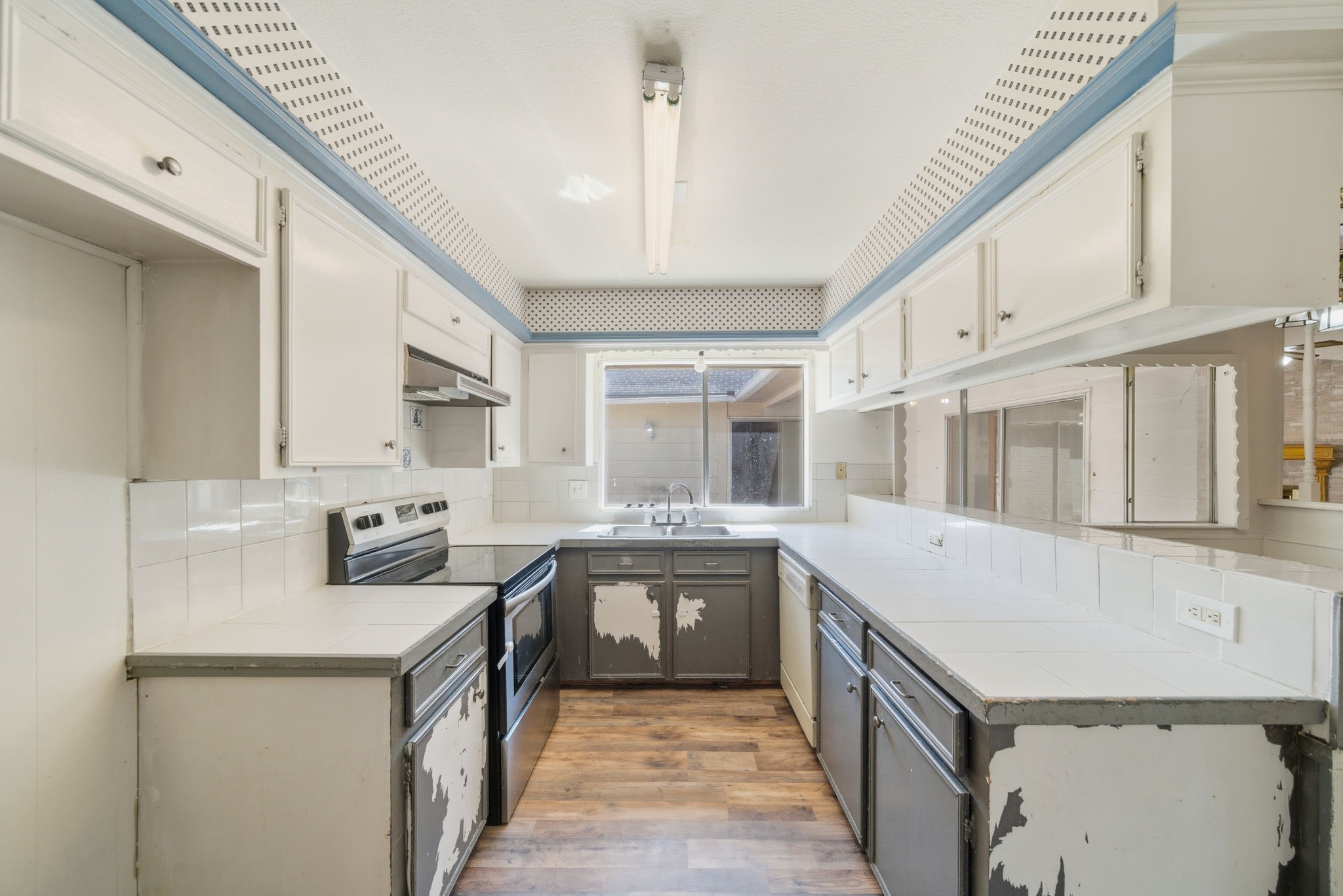 6919 River Mill Drive Spring, TX 77379 - Photo 9 of 20 a kitchen with a sink stove and cabinets