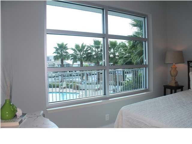 211 Durango Road, Unit 213 Destin, FL 32541 - Photo 18 of 32 a living room with a large window and a bed