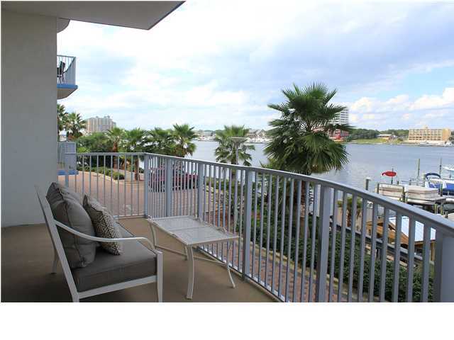 211 Durango Road, Unit 213 Destin, FL 32541 - Photo 4 of 32 a balcony with wooden floor table and chairs