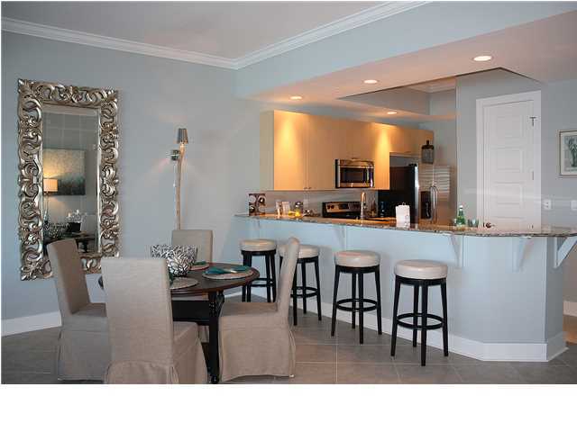 211 Durango Road, Unit 213 Destin, FL 32541 - Photo 8 of 32 a kitchen with a table and chairs