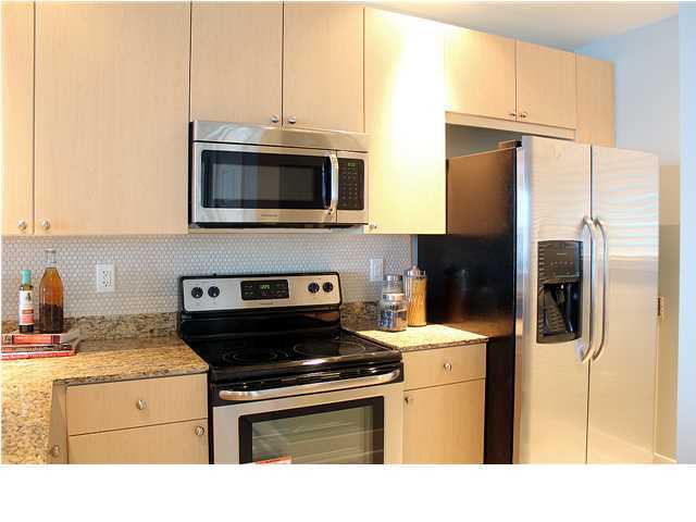211 Durango Road, Unit 213 Destin, FL 32541 - Photo 10 of 32 a kitchen with stainless steel appliances granite countertop a stove a refrigerator and a microwave