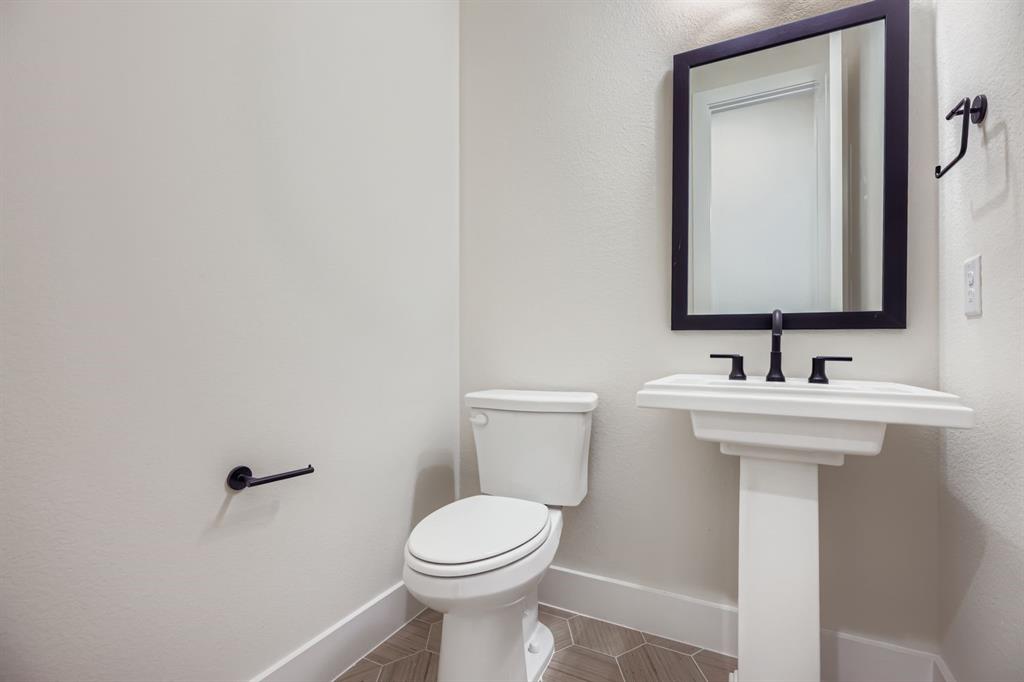 4813 Strada Street Prosper, TX 75078 - Photo 11 of 28 a bathroom with a sink mirror and toilet