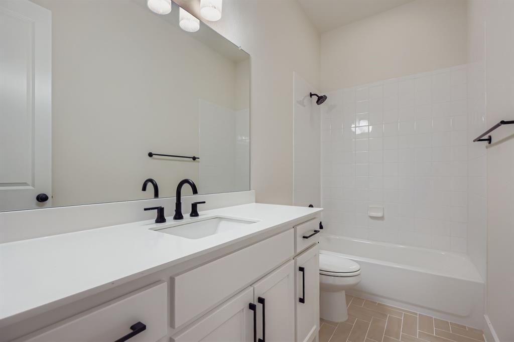 4813 Strada Street Prosper, TX 75078 - Photo 18 of 28 a bathroom with a sink toilet and shower