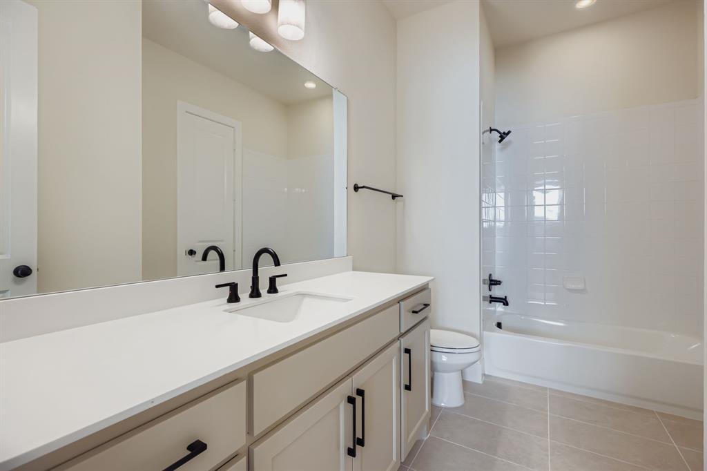 4813 Strada Street Prosper, TX 75078 - Photo 20 of 28 a bathroom with a sink a toilet and shower