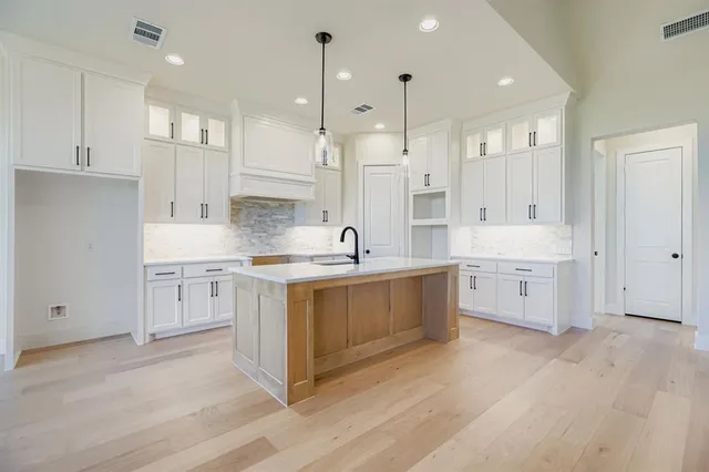 a large white kitchen with a lot of counter space