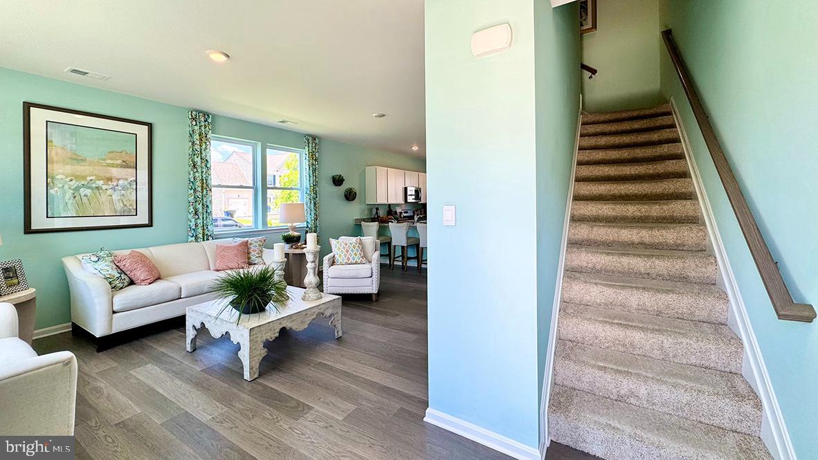 822 Mersey Lane Salisbury, MD 21801 - Photo 2 of 28 a living room with furniture and a stair