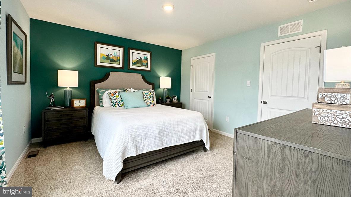 822 Mersey Lane Salisbury, MD 21801 - Photo 27 of 28 a bedroom with a bed and painting on the wall