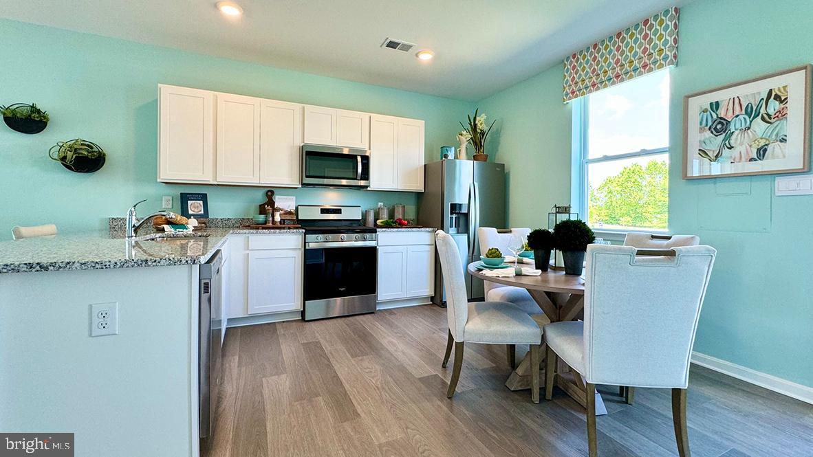 822 Mersey Lane Salisbury, MD 21801 - Photo 8 of 28 a kitchen with furniture wooden floor cabinets and appliances