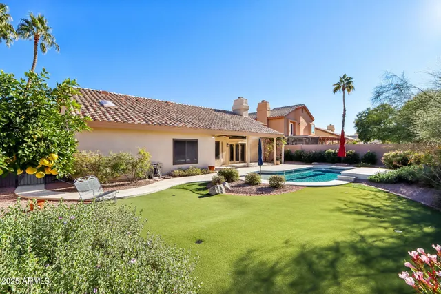 a view of a house with swimming pool and sitting area