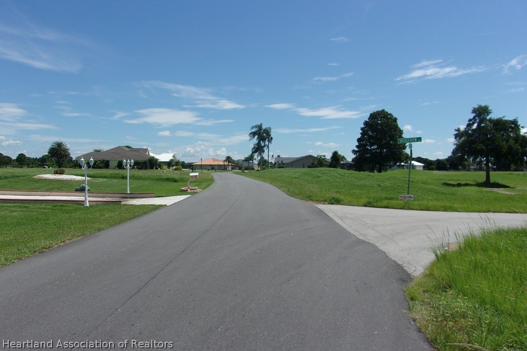 6609 Concord Street Sebring, FL 33876 - Photo 5 of 14 a view of a golf course with a road