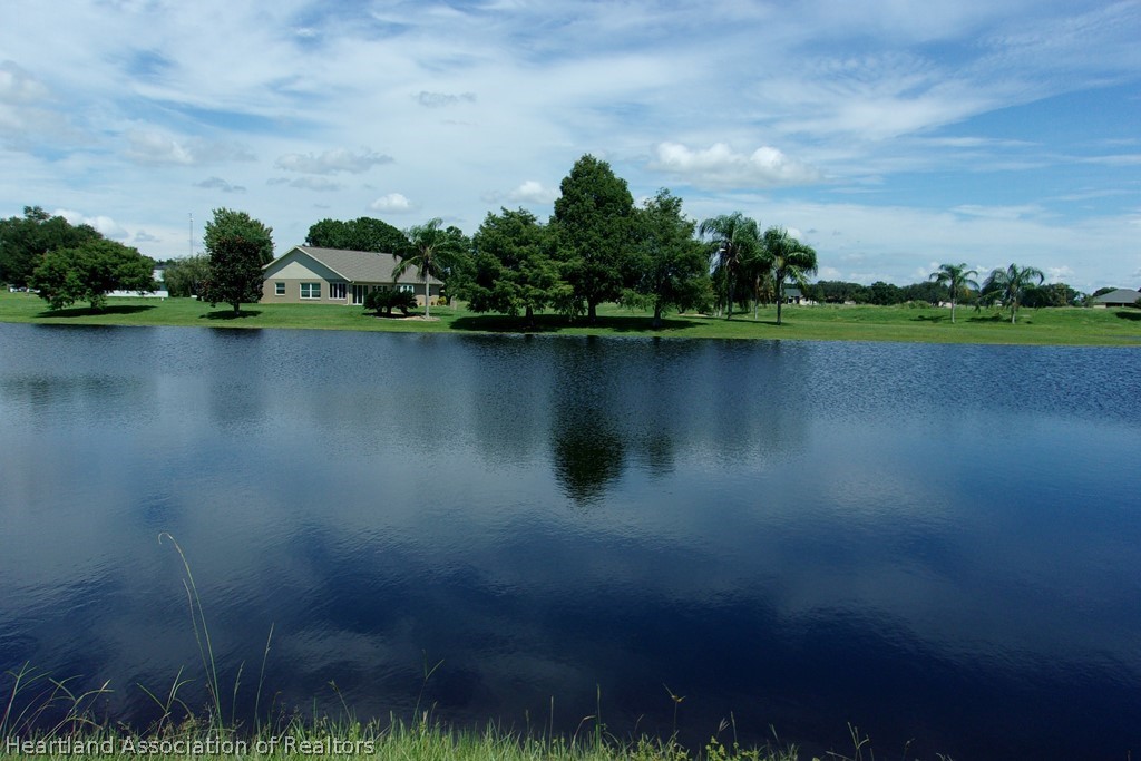 6609 Concord Street Sebring, FL 33876 - Photo 8 of 14 a view of a lake with houses in the background