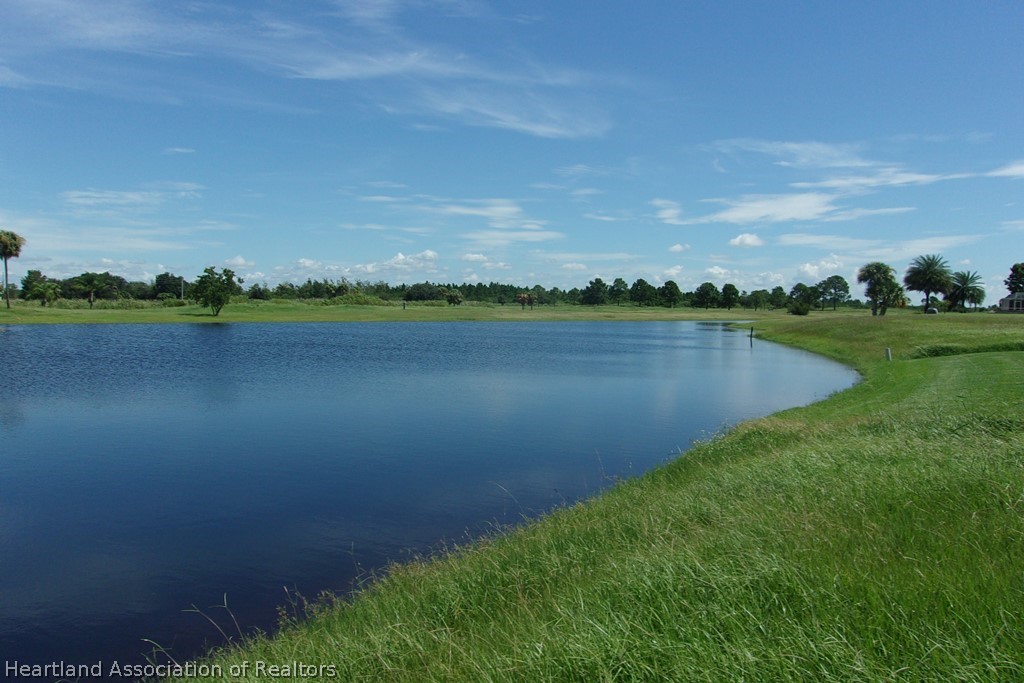 6609 Concord Street Sebring, FL 33876 - Photo 9 of 14 a view of a lake with houses in the back