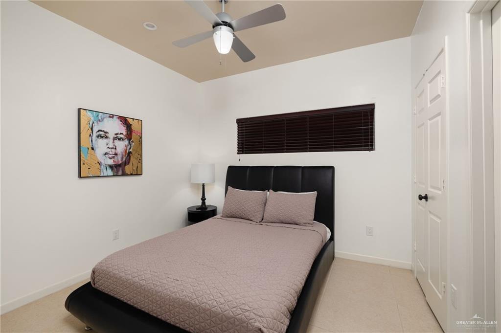 813 Travis Street, Unit 314 Mission, TX 78572 - Photo 11 of 26 a bedroom with a bed and a walk in closet