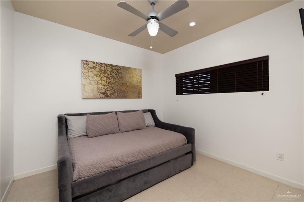 813 Travis Street, Unit 314 Mission, TX 78572 - Photo 12 of 26 a bedroom with a bed and a walk in closet
