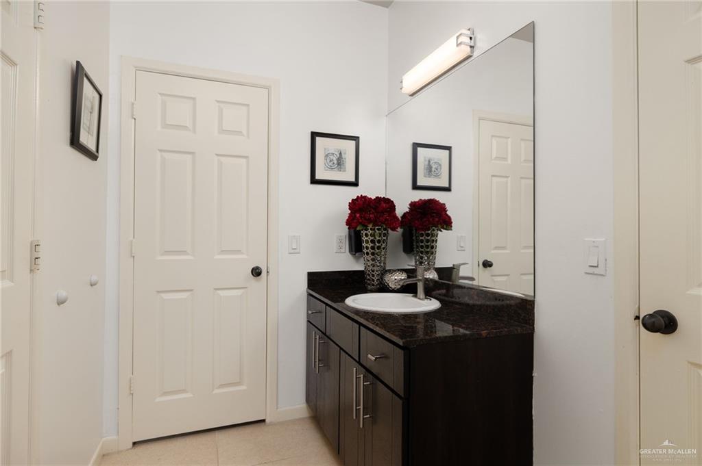 813 Travis Street, Unit 314 Mission, TX 78572 - Photo 13 of 26 a bathroom with a sink and a mirror