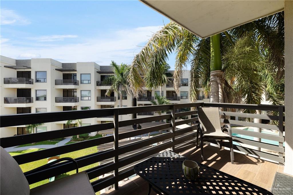 813 Travis Street, Unit 314 Mission, TX 78572 - Photo 15 of 26 a view of a balcony with chairs and wooden fence