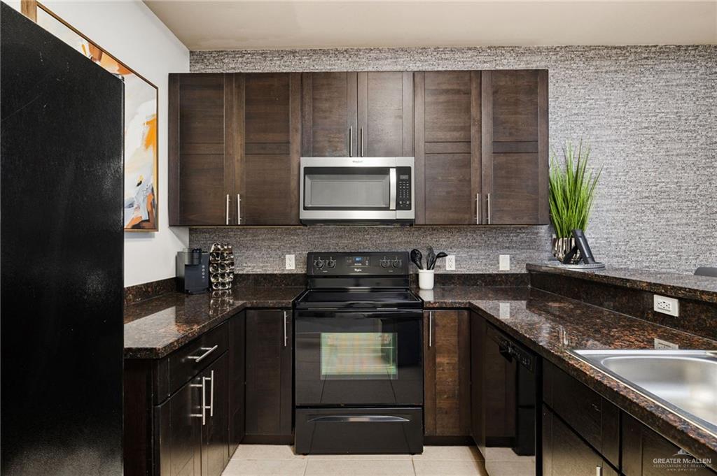 813 Travis Street, Unit 314 Mission, TX 78572 - Photo 4 of 26 a kitchen with a sink stove and microwave