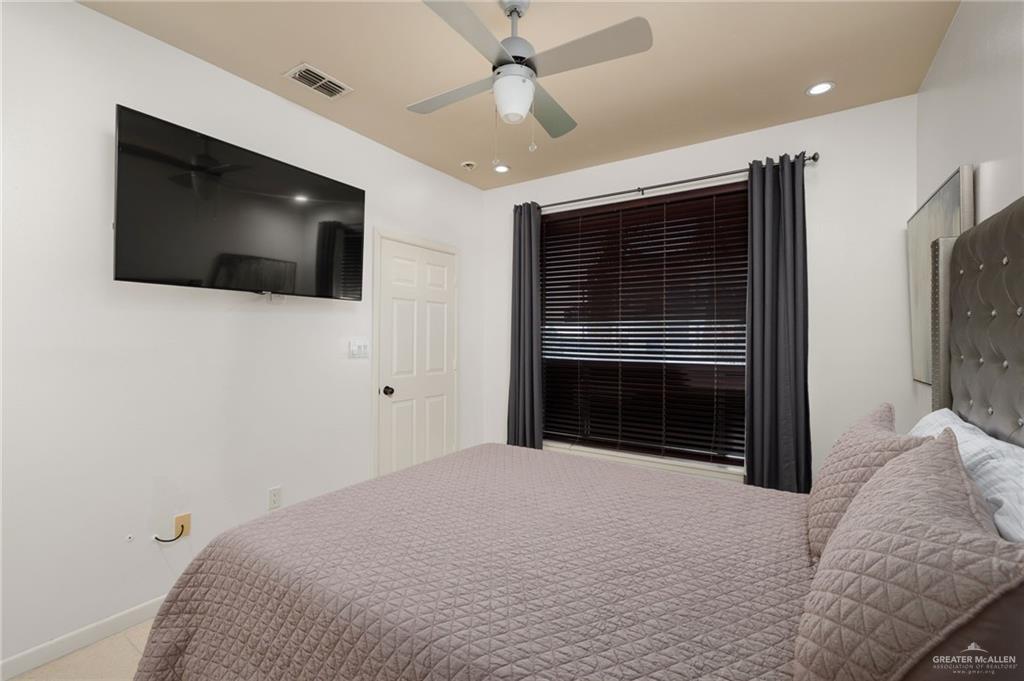 813 Travis Street, Unit 314 Mission, TX 78572 - Photo 10 of 26 a bedroom with a bed and a flat screen tv