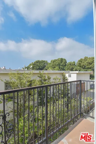 a view of a kitchen with refrigerator and windows