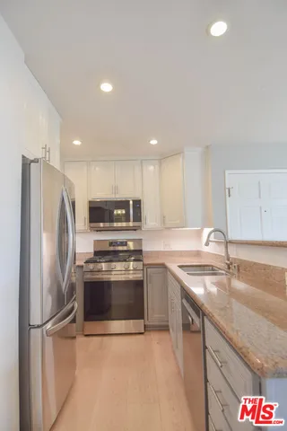a kitchen with a refrigerator sink and microwave