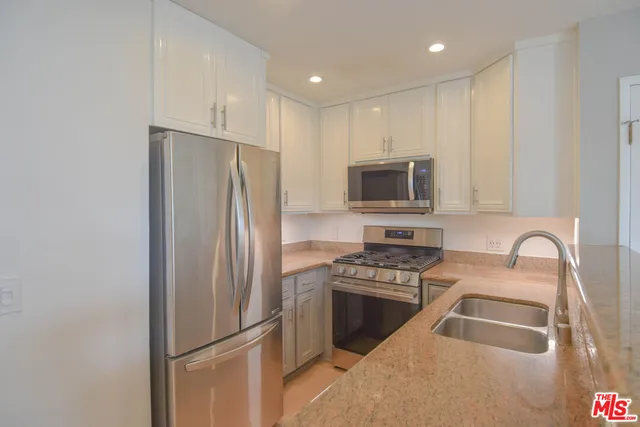 a bathroom with a toilet a sink and a mirror