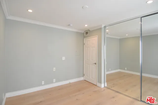 a bedroom with a bed and wall painting