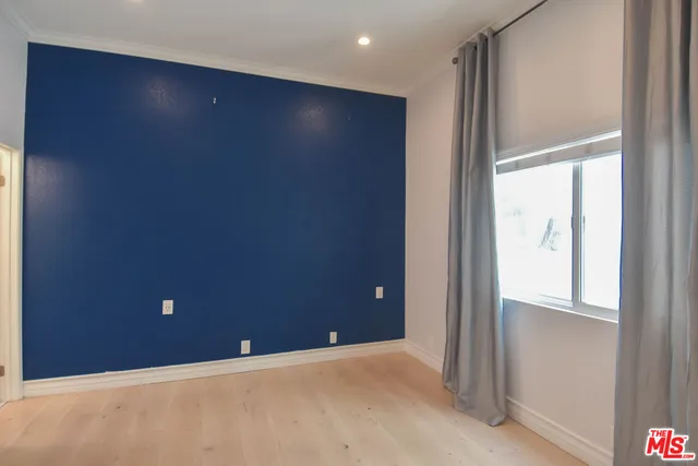 a bathroom with a granite countertop sink a toilet a mirror and shower
